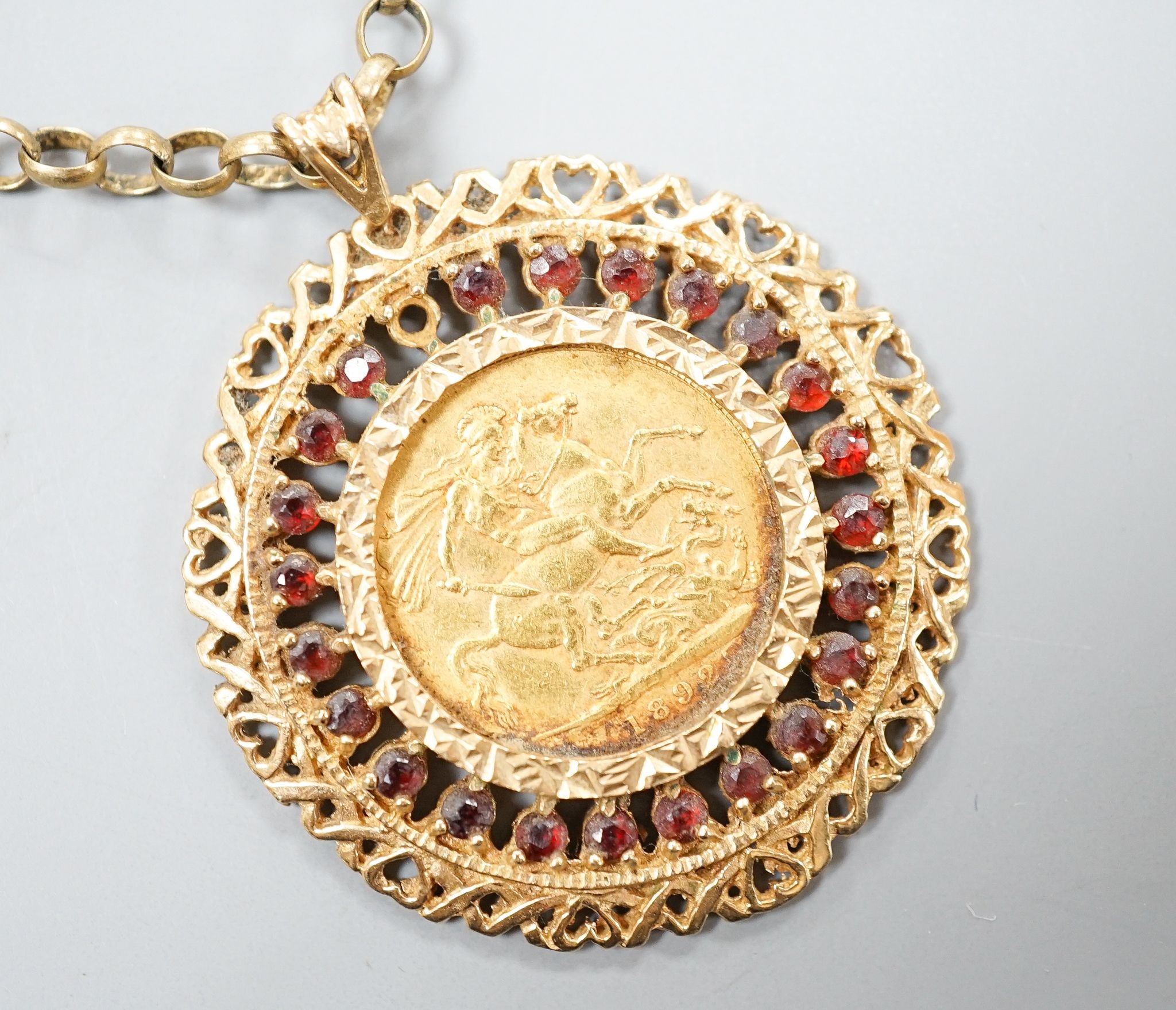 An 1892 gold sovereign, in a 9ct gold and garnet? set pendant mount on a 9ct gold chain, gross weight 29.2 grams.